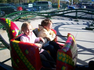 Jess and Tim on the kids roller coaster, he is a daredevil, and she was willing to try anything that day. 
